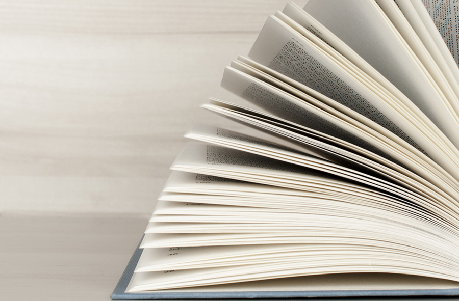 open blue books and wooden wall